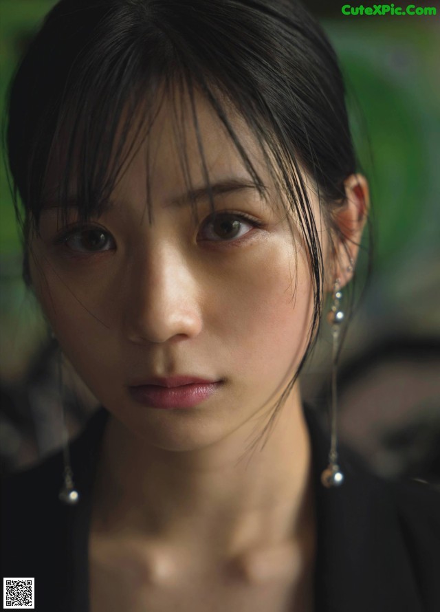 A close up of a woman with long black hair.