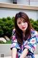 A woman in a blue and pink kimono posing for a picture.