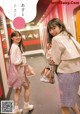 A couple of women standing next to each other in a hallway.